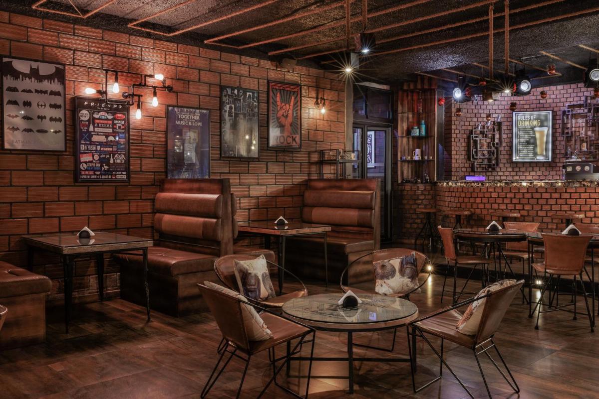 a restaurant with tables and chairs and a brick wall at The Panoramic Getaway in Munnar