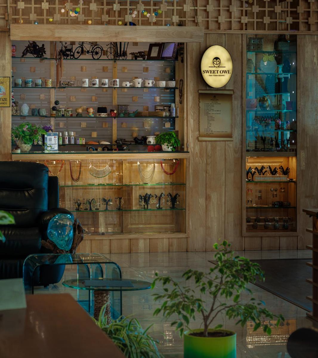 a restaurant with a table and a shelf with dishes at The Panoramic Getaway in Munnar