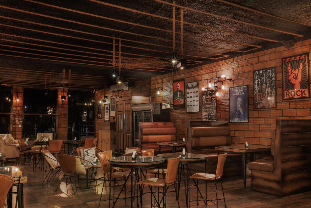 a restaurant with tables and chairs and a brick wall at The Panoramic Getaway in Munnar