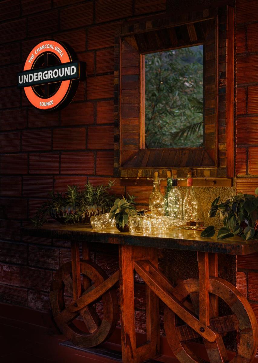 a table in a cabin with a sign on the wall at The Panoramic Getaway in Munnar