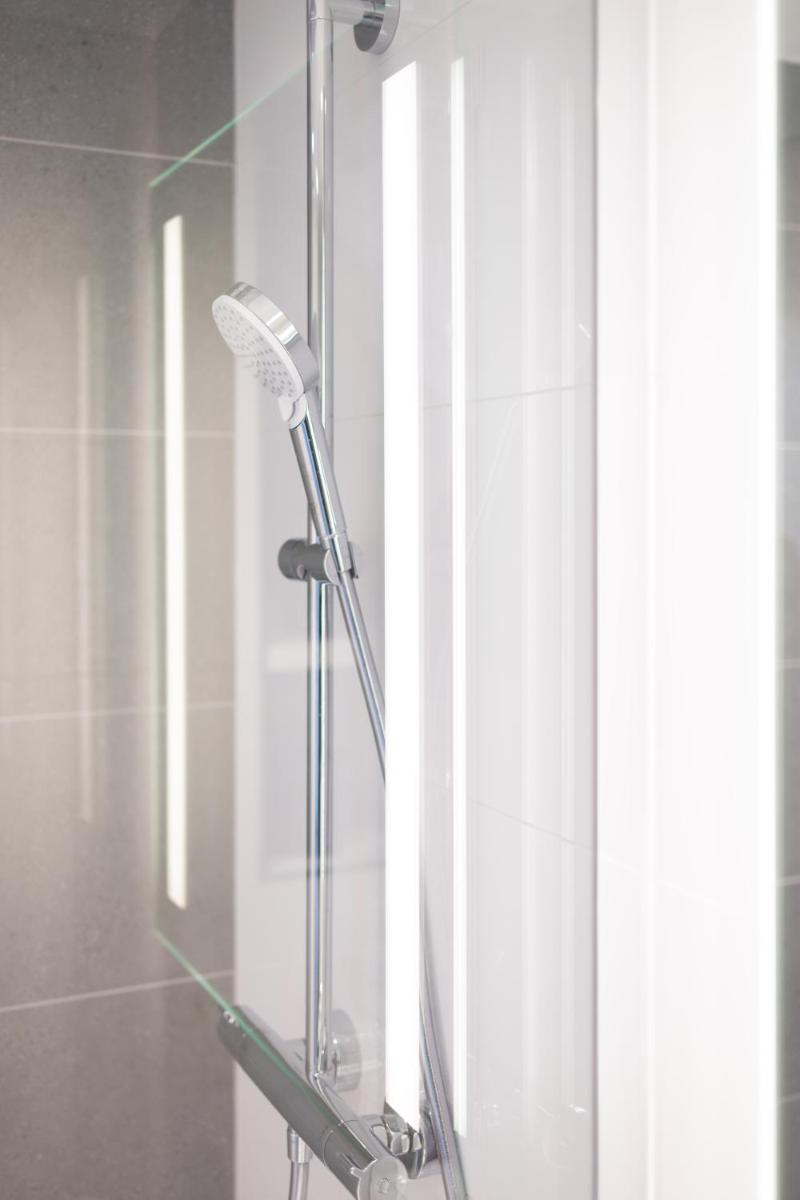 une douche avec sèche-cheveux dans une salle de bain dans l'établissement Hôtel Riva Art & Spa, à Menton