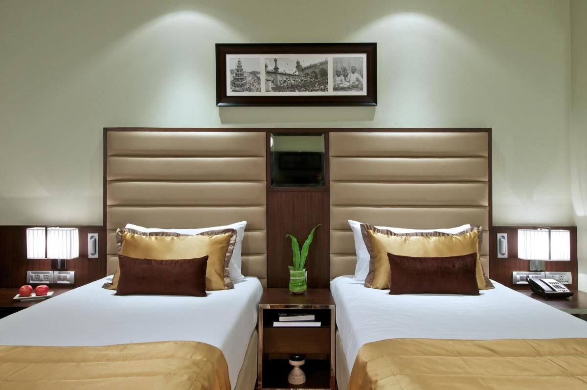 two beds sitting next to each other in a hotel room at Vivanta Hyderabad, Begumpet in Hyderabad two beds sitting next to each other in a hotel room at Vivanta Hyderabad, Begumpet in Hyderabad