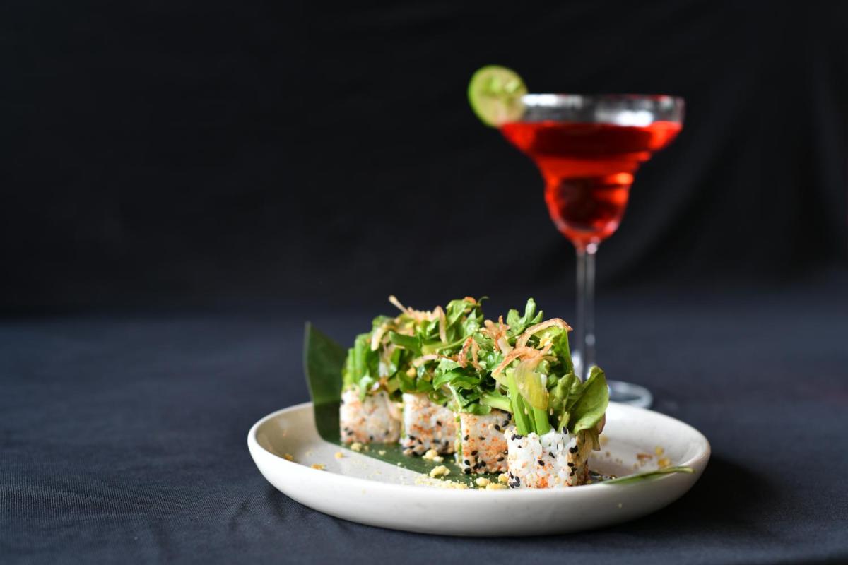 a plate of food and a glass of wine at Hyatt Ahmedabad in Ahmedabad