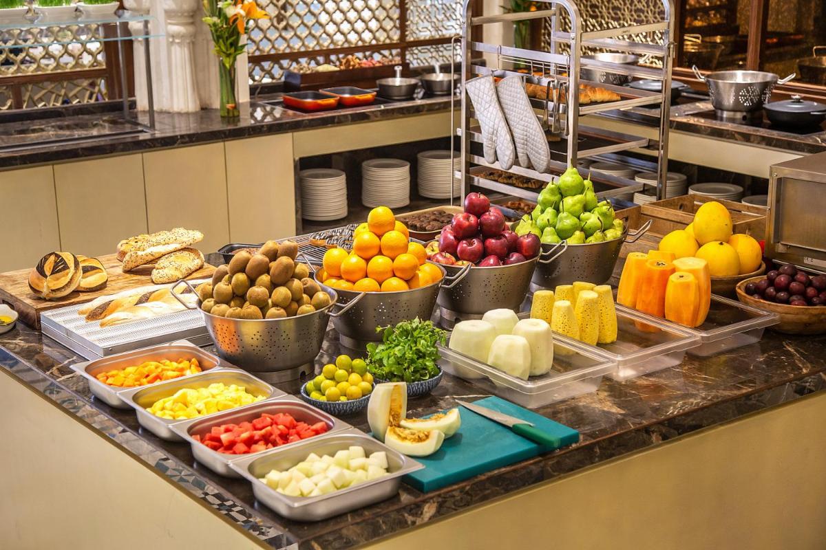 a buffet of fruits and vegetables on a counter at Hyatt Regency Jaipur Mansarovar in Jaipur a buffet of fruits and vegetables on a counter at Hyatt Regency Jaipur Mansarovar in Jaipur