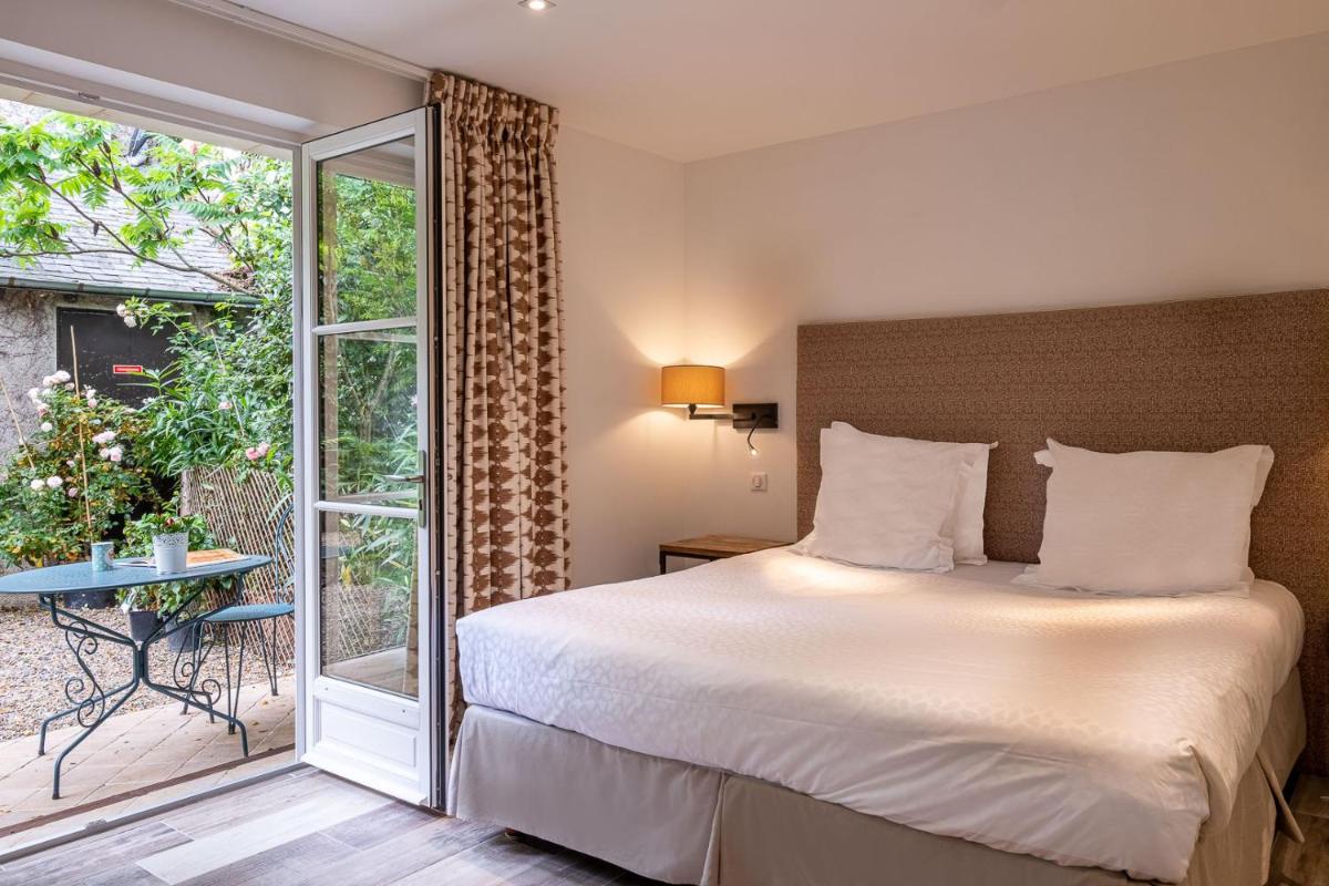 Un ou plusieurs lits dans un hébergement de l'établissement Auberge du Bon Laboureur Chenonceaux