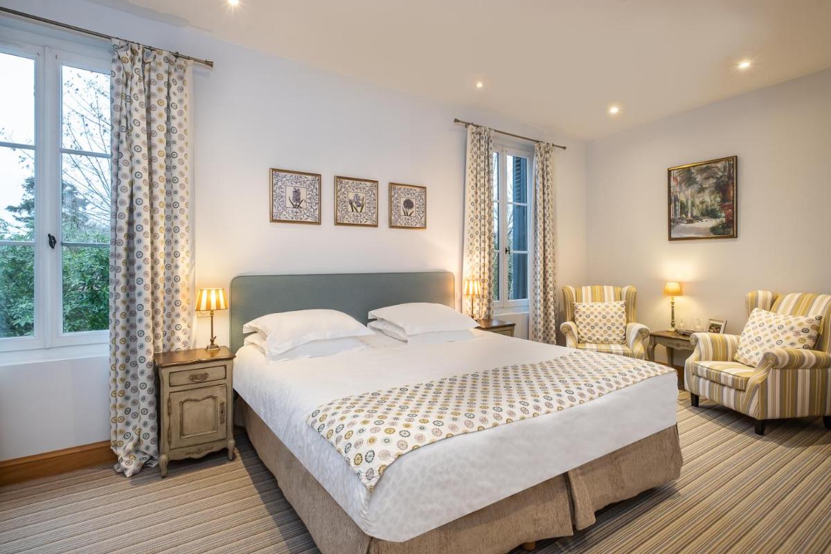 Un ou plusieurs lits dans un hébergement de l'établissement Auberge du Bon Laboureur Chenonceaux