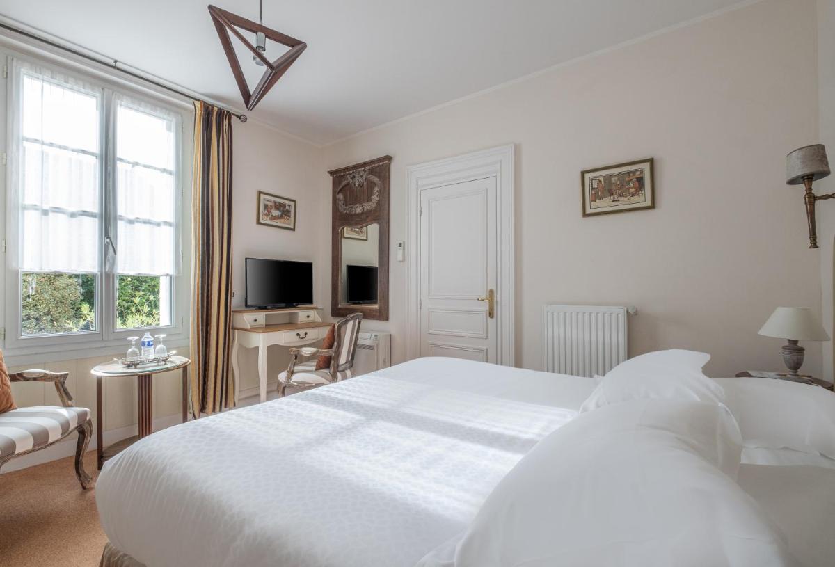 Un ou plusieurs lits dans un hébergement de l'établissement Auberge du Bon Laboureur Chenonceaux