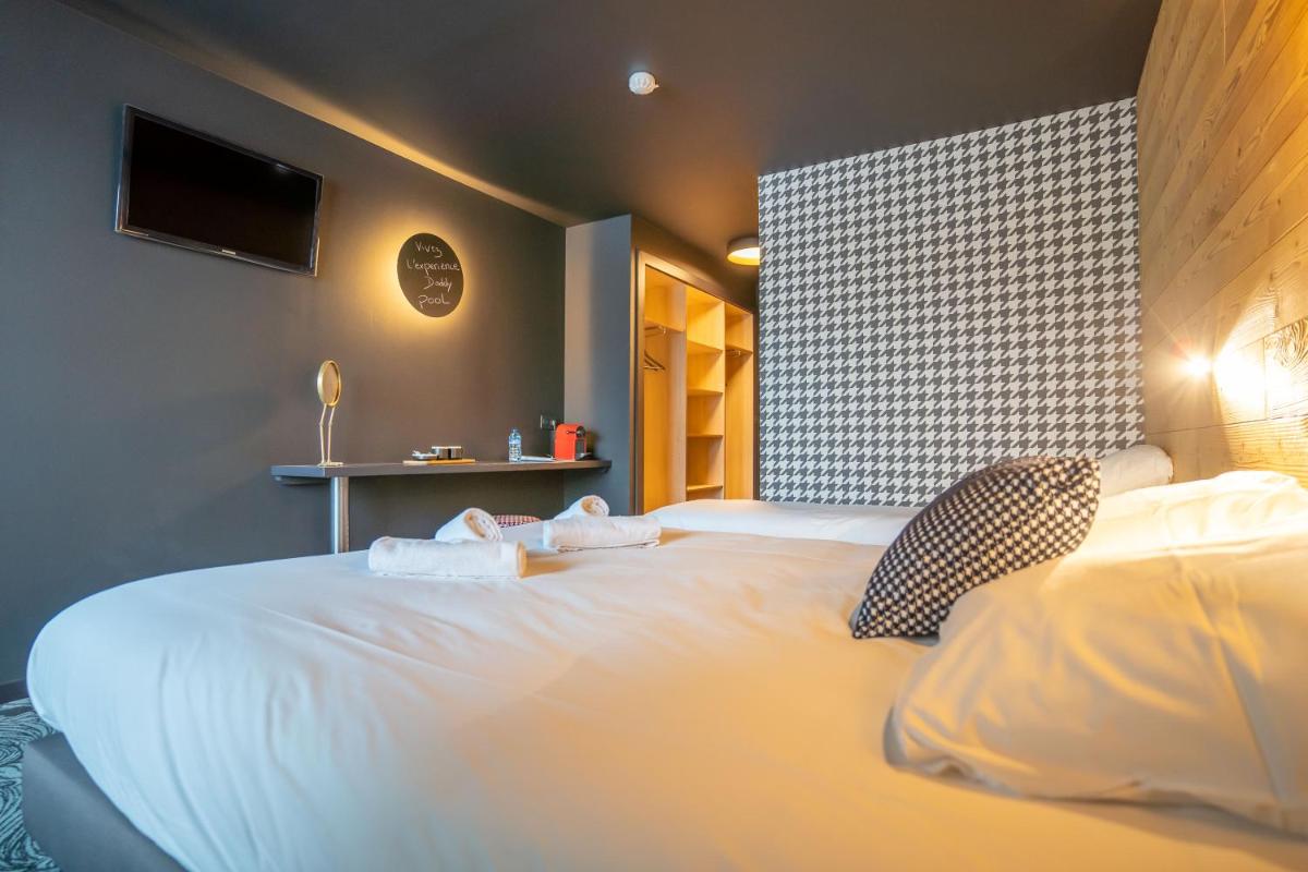 Un ou plusieurs lits dans un hébergement de l'établissement Hôtel Le Cristal Lodge - TERRESENS