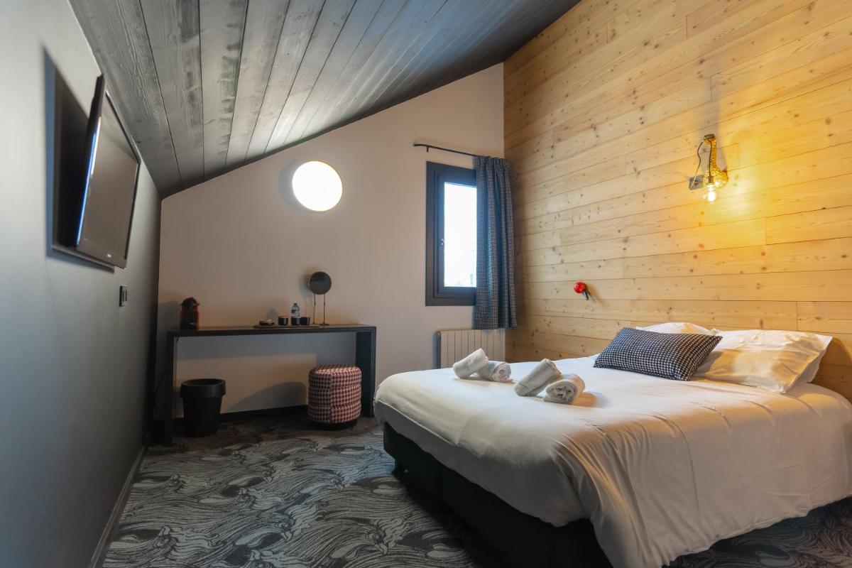 Un ou plusieurs lits dans un hébergement de l'établissement Hôtel Le Cristal Lodge - TERRESENS