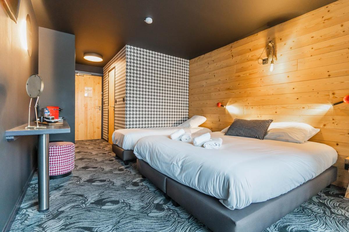 Un ou plusieurs lits dans un hébergement de l'établissement Hôtel Le Cristal Lodge - TERRESENS