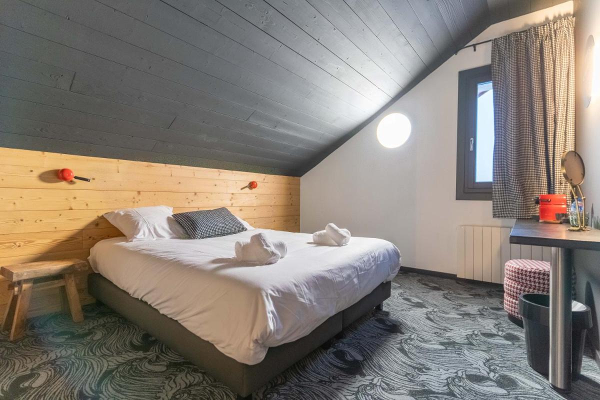 Un ou plusieurs lits dans un hébergement de l'établissement Hôtel Le Cristal Lodge - TERRESENS