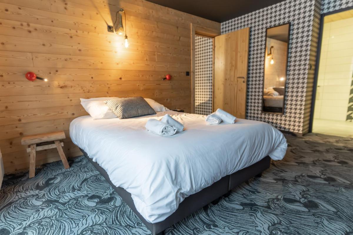 Un ou plusieurs lits dans un hébergement de l'établissement Hôtel Le Cristal Lodge - TERRESENS