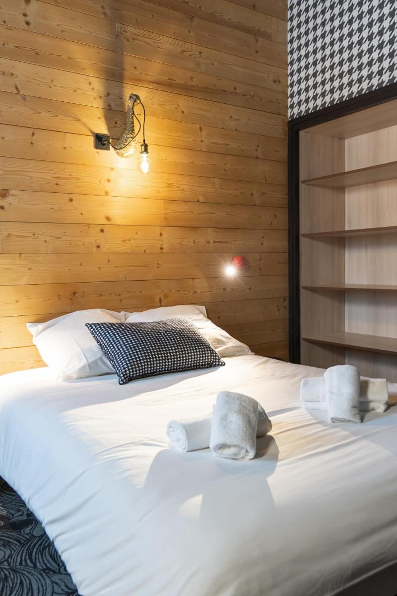 Un ou plusieurs lits dans un hébergement de l'établissement Hôtel Le Cristal Lodge - TERRESENS