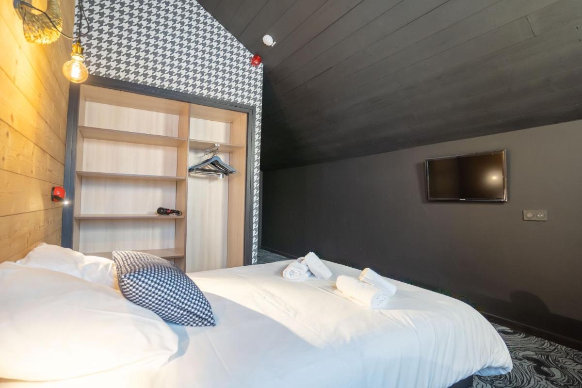Un ou plusieurs lits dans un hébergement de l'établissement Hôtel Le Cristal Lodge - TERRESENS