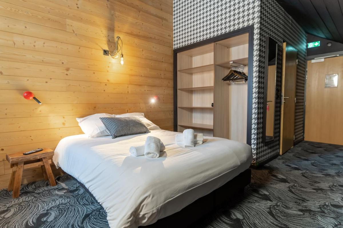 Un ou plusieurs lits dans un hébergement de l'établissement Hôtel Le Cristal Lodge - TERRESENS
