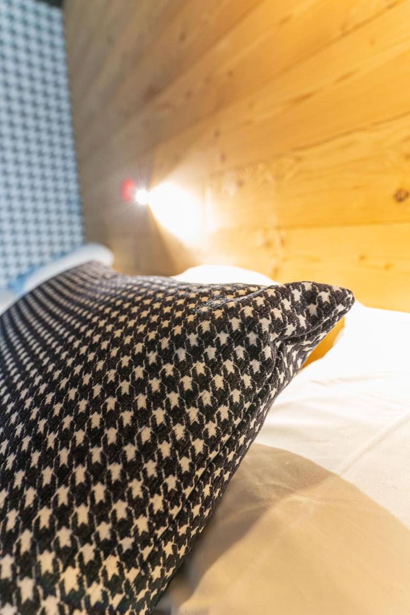 Un ou plusieurs lits dans un hébergement de l'établissement Hôtel Le Cristal Lodge - TERRESENS