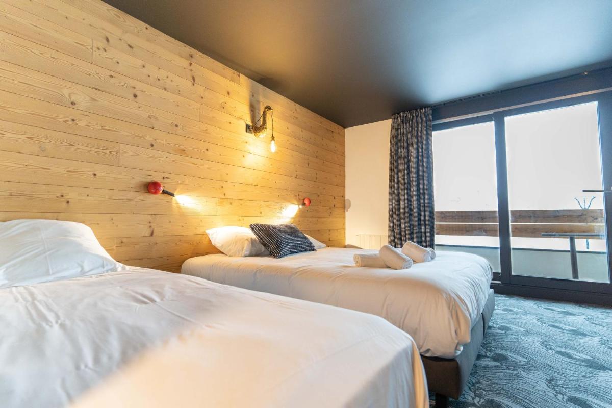 Un ou plusieurs lits dans un hébergement de l'établissement Hôtel Le Cristal Lodge - TERRESENS