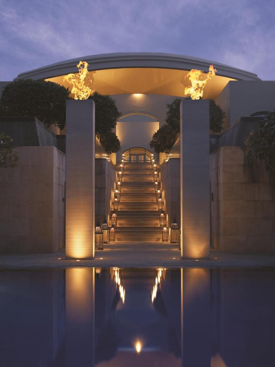 a set of stairs leading up to a building with lights at Trident Gurgaon in Gurgaon