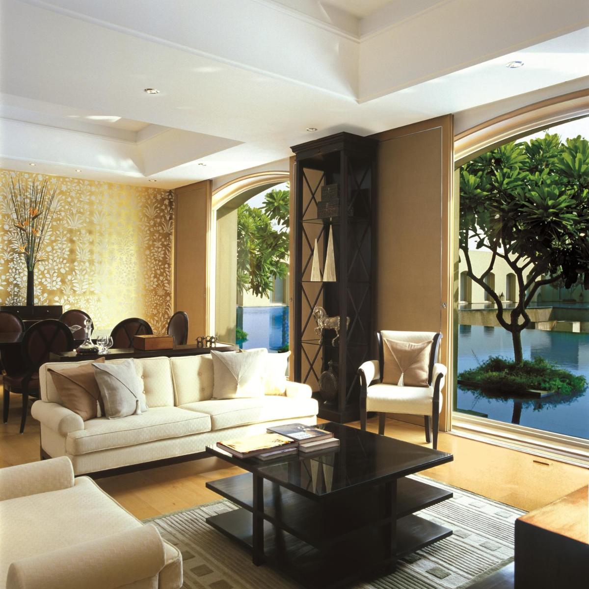 a living room with a couch and a table at Trident Gurgaon in Gurgaon