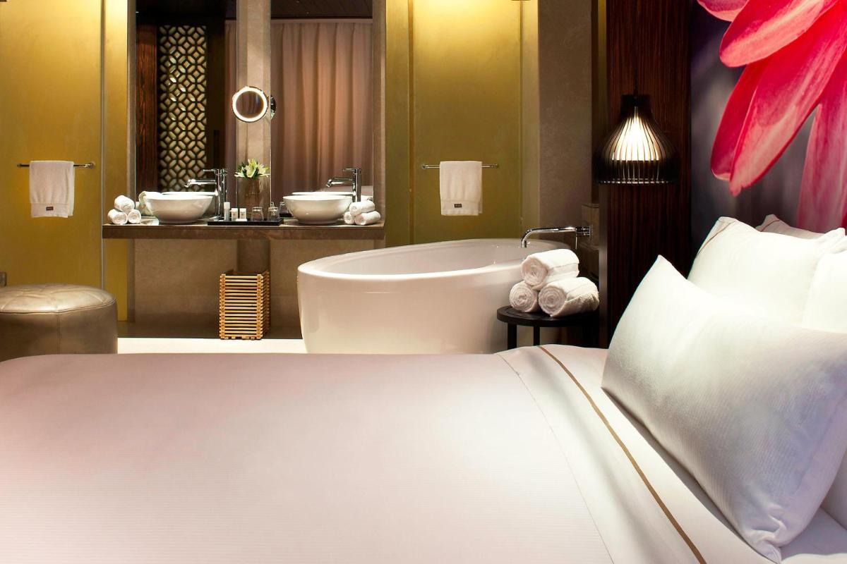 a hotel room with a bed and a bath tub at The Westin Hyderabad Mindspace in Hyderabad