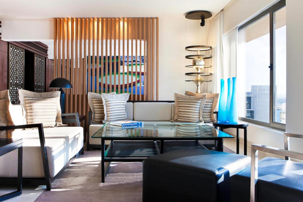 a living room with a couch and a table at The Westin Hyderabad Mindspace in Hyderabad