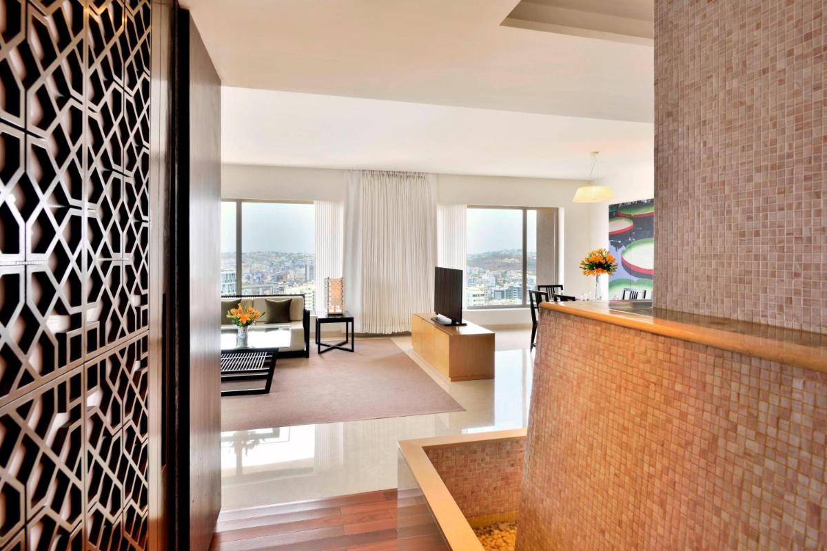 a living room with a brick wall at The Westin Hyderabad Mindspace in Hyderabad