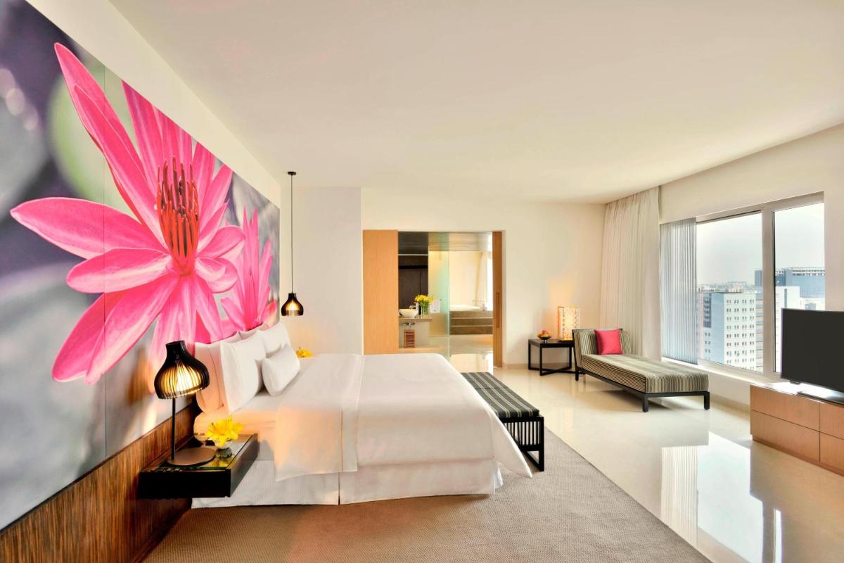 a bedroom with a large pink flower on the wall at The Westin Hyderabad Mindspace in Hyderabad