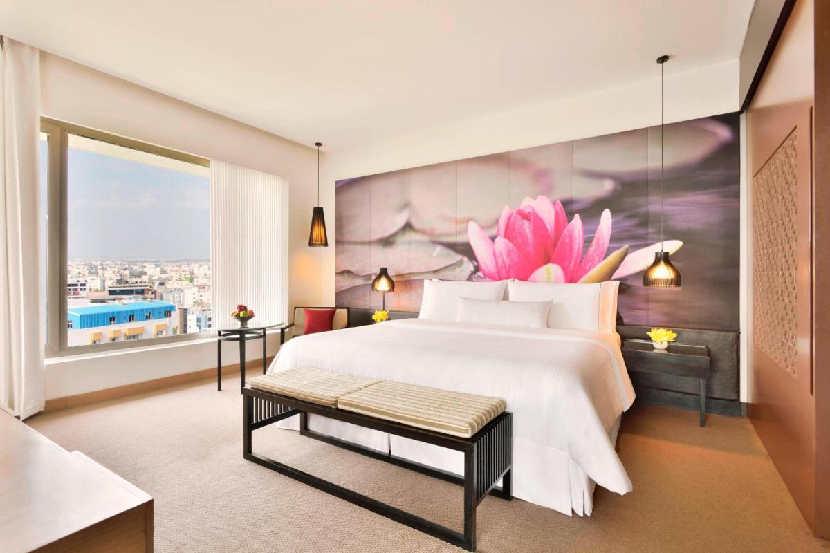 a bedroom with a large bed and a large window at The Westin Hyderabad Mindspace in Hyderabad