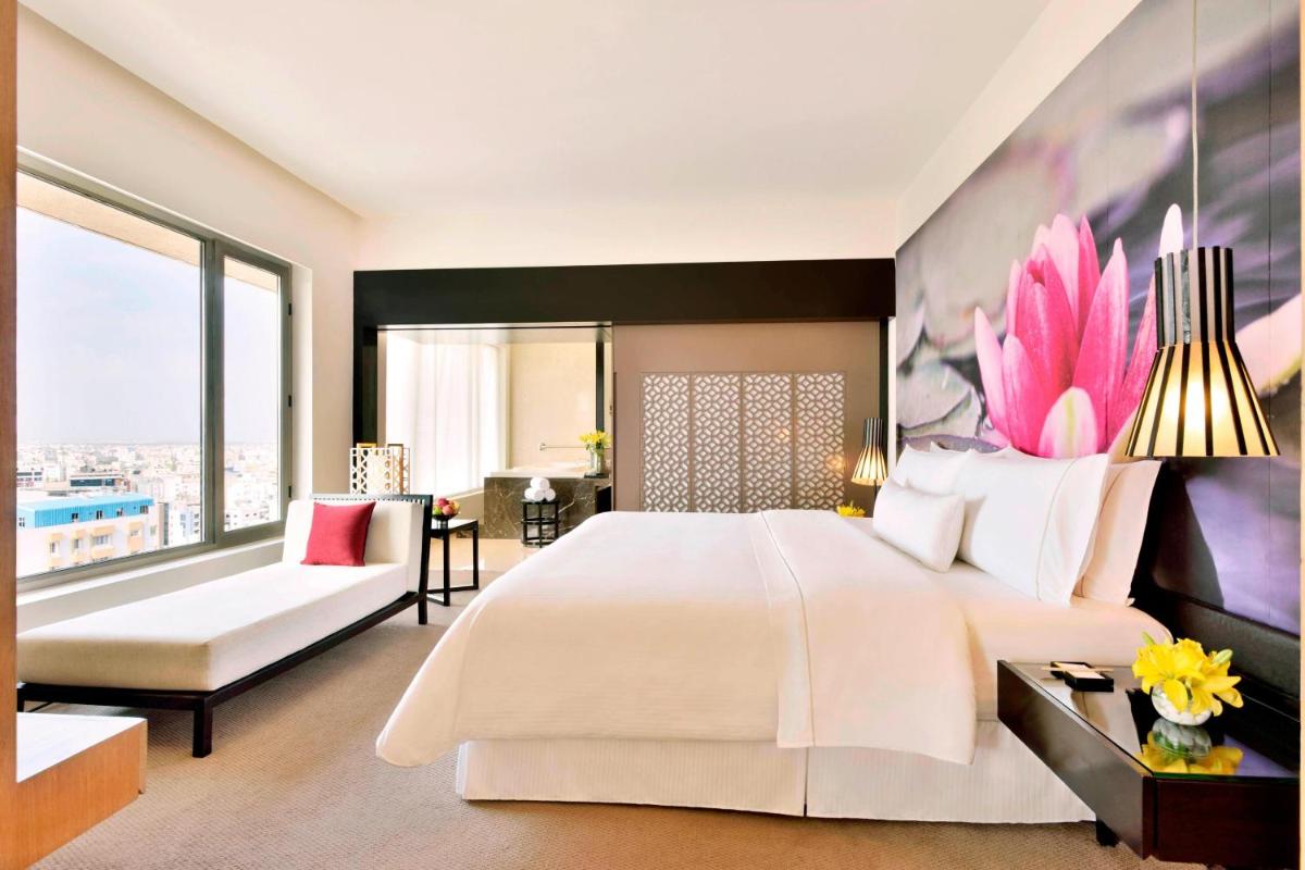 a bedroom with a large bed and a large window at The Westin Hyderabad Mindspace in Hyderabad