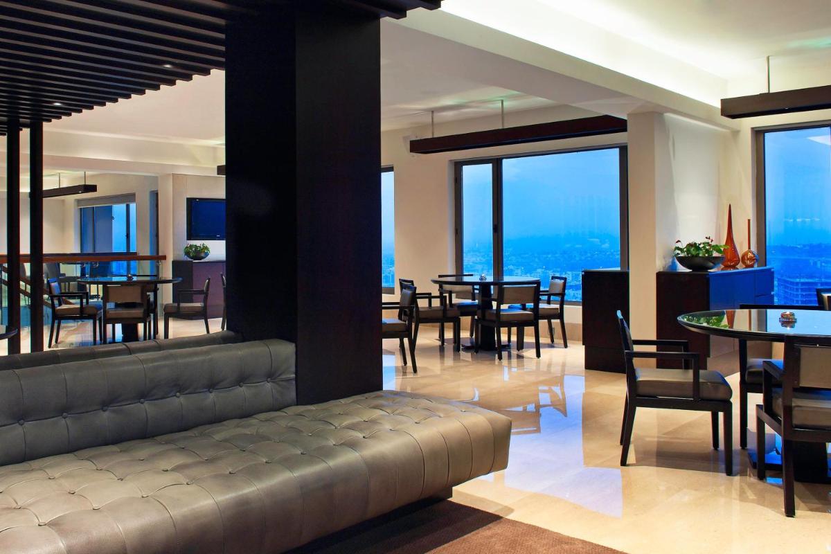 two pictures of a restaurant with tables and chairs at The Westin Hyderabad Mindspace in Hyderabad