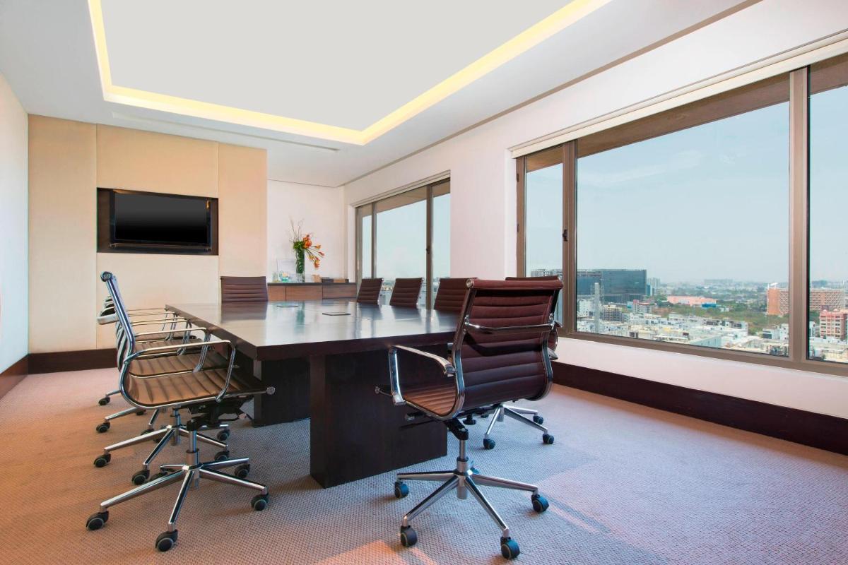 a conference room with a large table and chairs at The Westin Hyderabad Mindspace in Hyderabad