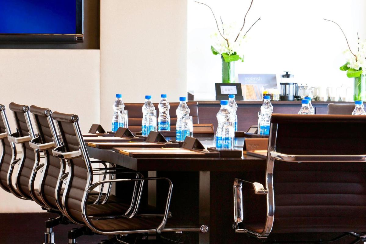 a table with bottles of water on top of it at The Westin Hyderabad Mindspace in Hyderabad