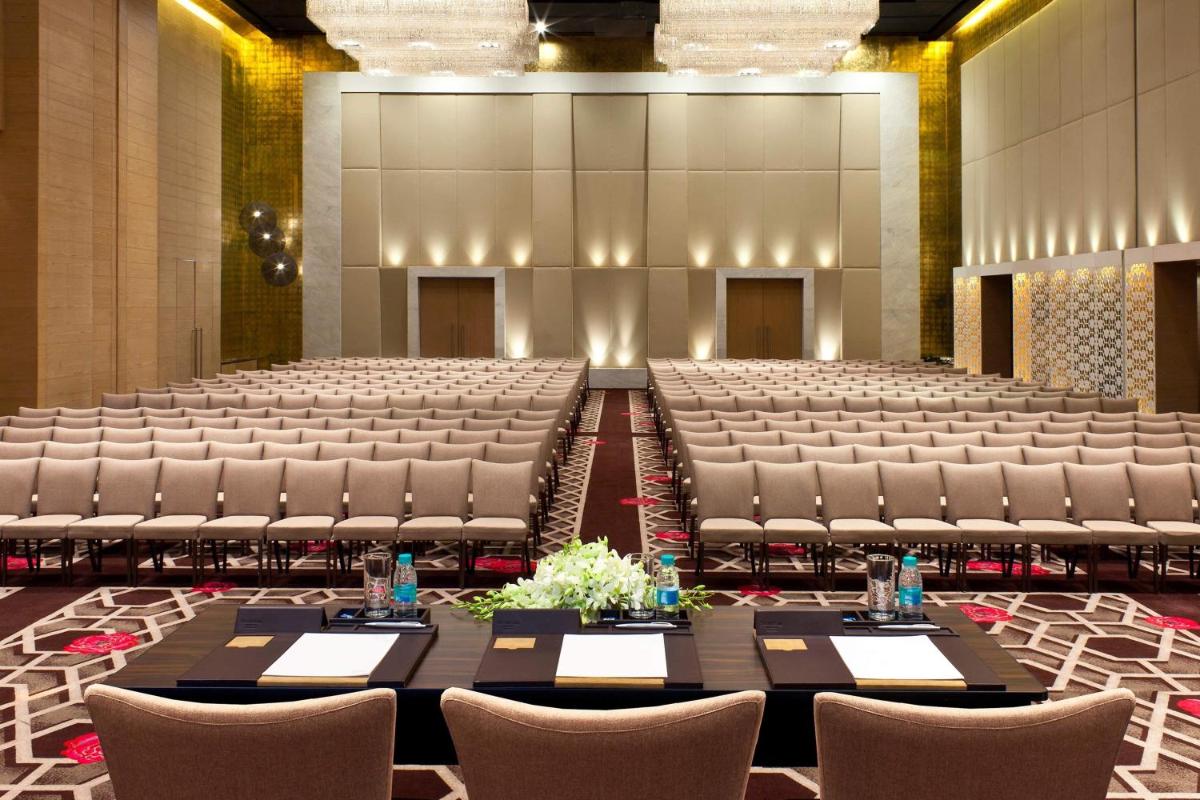 a large hall with tables and chairs in it at The Westin Hyderabad Mindspace in Hyderabad