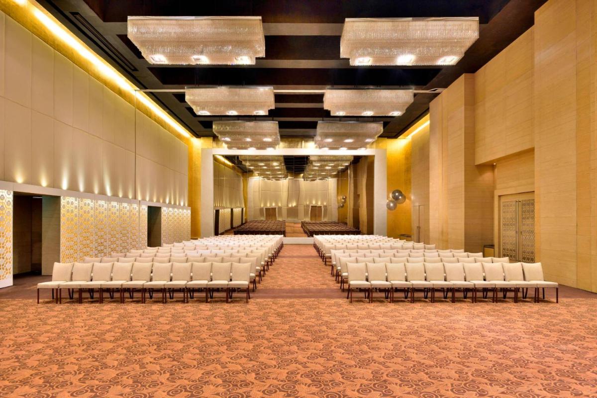 an empty banquet hall with rows of white chairs at The Westin Hyderabad Mindspace in Hyderabad