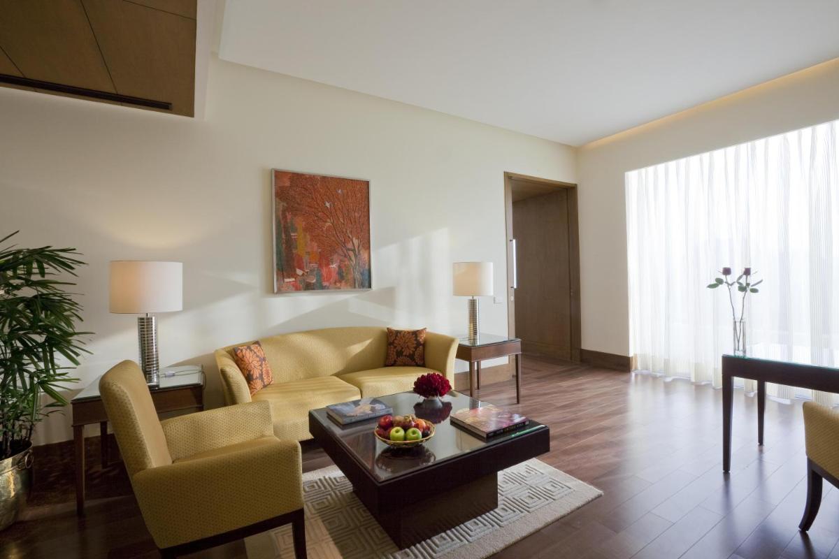 a living room with a couch and a table at The Oberoi Gurgaon in Gurgaon