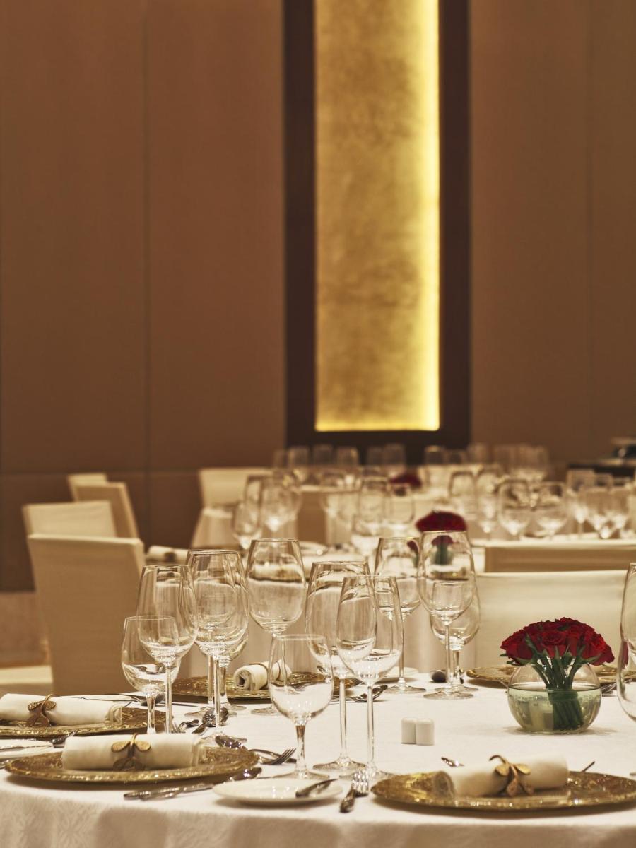 a long table with wine glasses on it at The Oberoi Gurgaon in Gurgaon