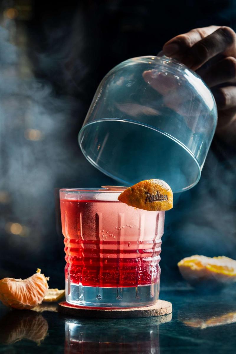 a glass of red drink with a fish on top at Radisson Blu Plaza Delhi Airport in New Delhi a glass of red drink with a fish on top at Radisson Blu Plaza Delhi Airport in New Delhi