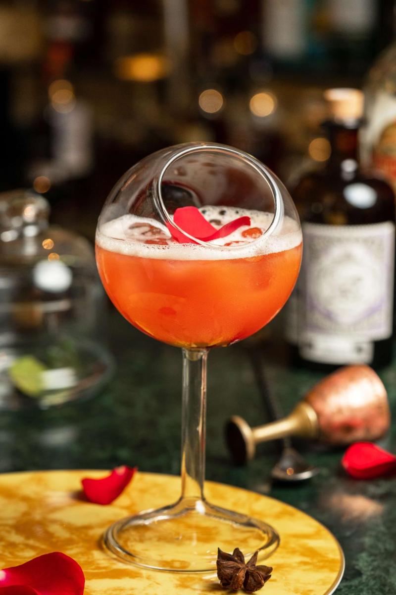 a drink in a wine glass on a table at Radisson Blu Plaza Delhi Airport in New Delhi a drink in a wine glass on a table at Radisson Blu Plaza Delhi Airport in New Delhi