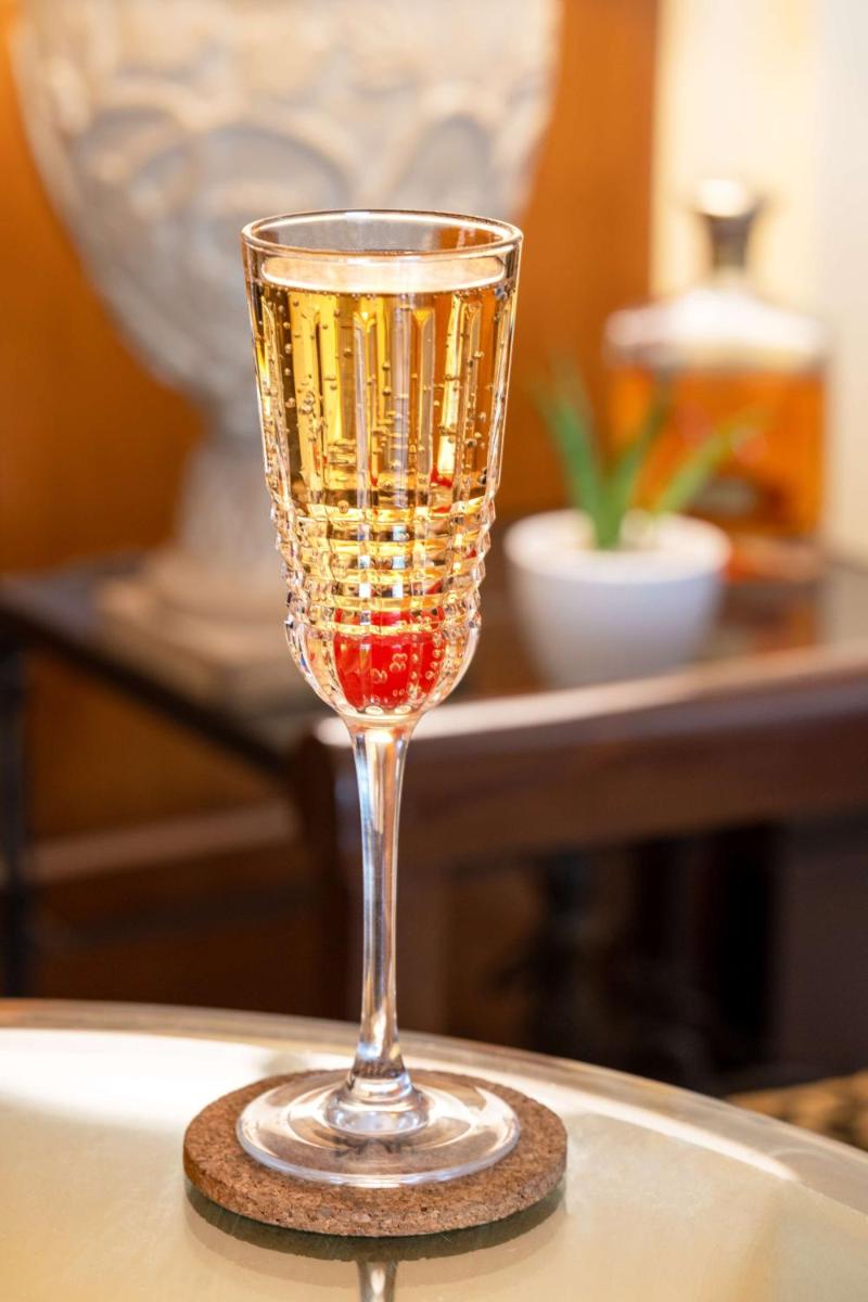 a glass of wine sitting on a table at Radisson Blu Plaza Delhi Airport in New Delhi a glass of wine sitting on a table at Radisson Blu Plaza Delhi Airport in New Delhi