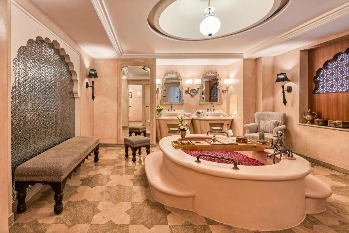a bathroom with a large tub and a sink at Fairmont Jaipur in Jaipur