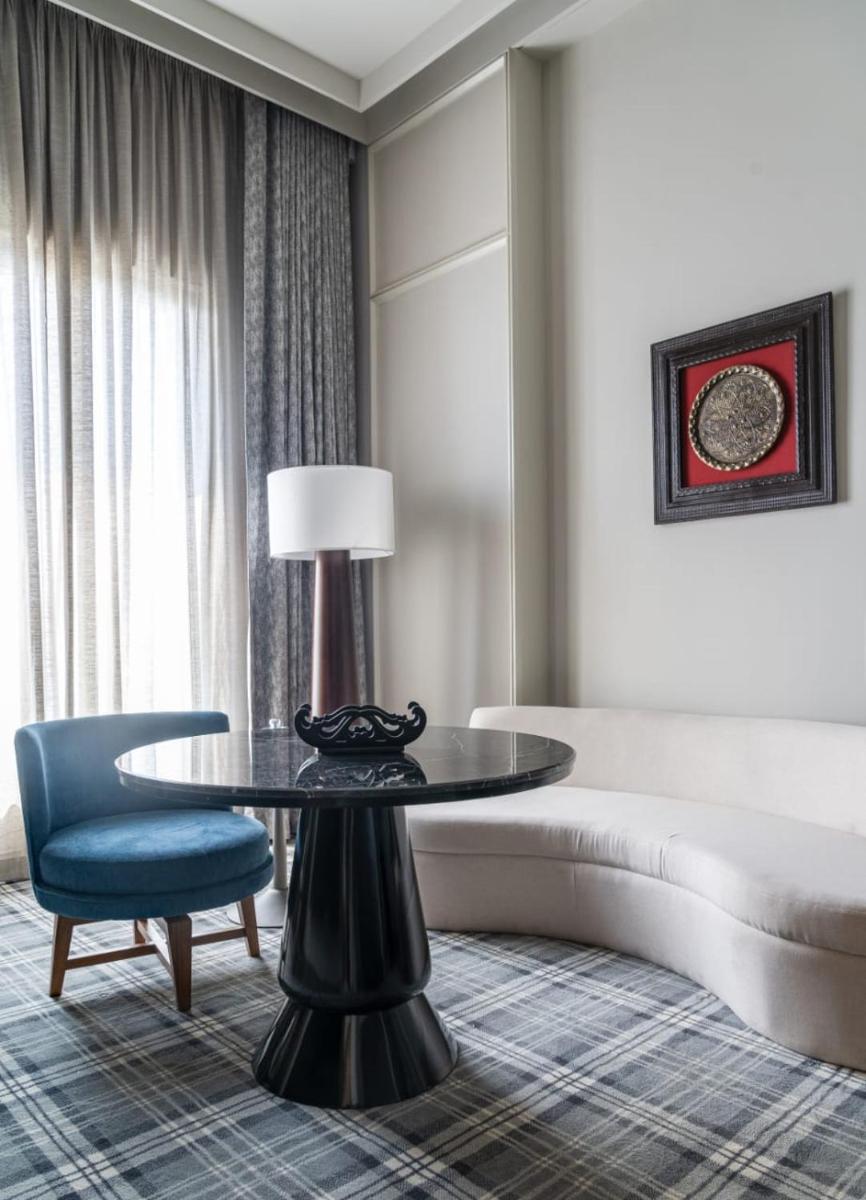 a living room with a table and a couch at The Residency Towers in Chennai