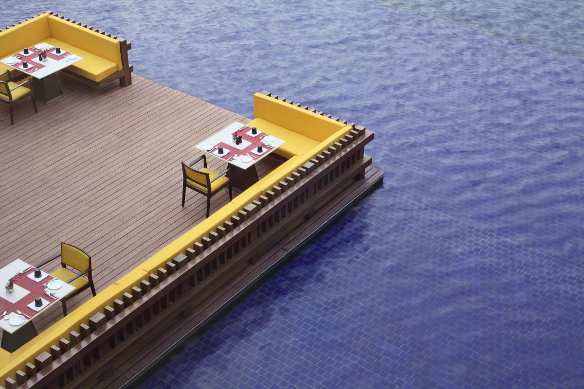 a rendering of a restaurant on the water at The Oberoi Gurgaon in Gurgaon