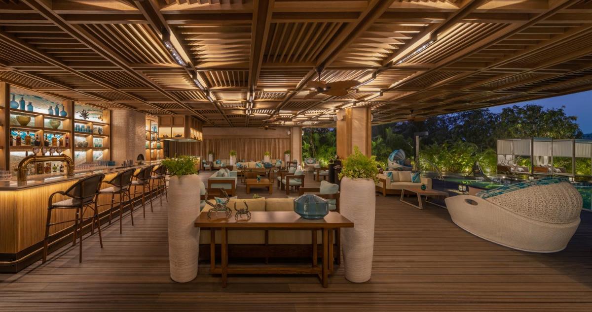 a rendering of a restaurant with tables and chairs at JW Marriott Goa in Vagator a rendering of a restaurant with tables and chairs at JW Marriott Goa in Vagator