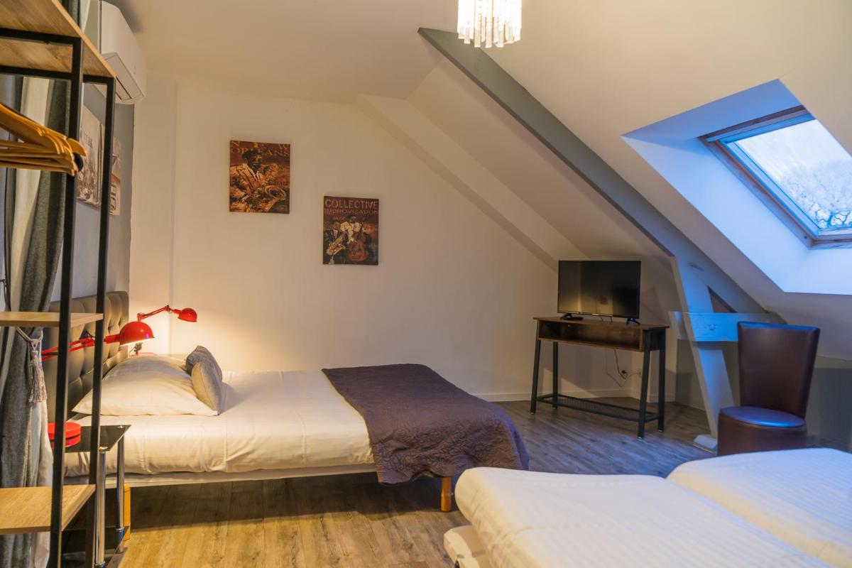 Un ou plusieurs lits dans un hébergement de l'établissement Les Terrasses de Saumur - Hôtel & Appartements - Restaurant & Spa (Logis)