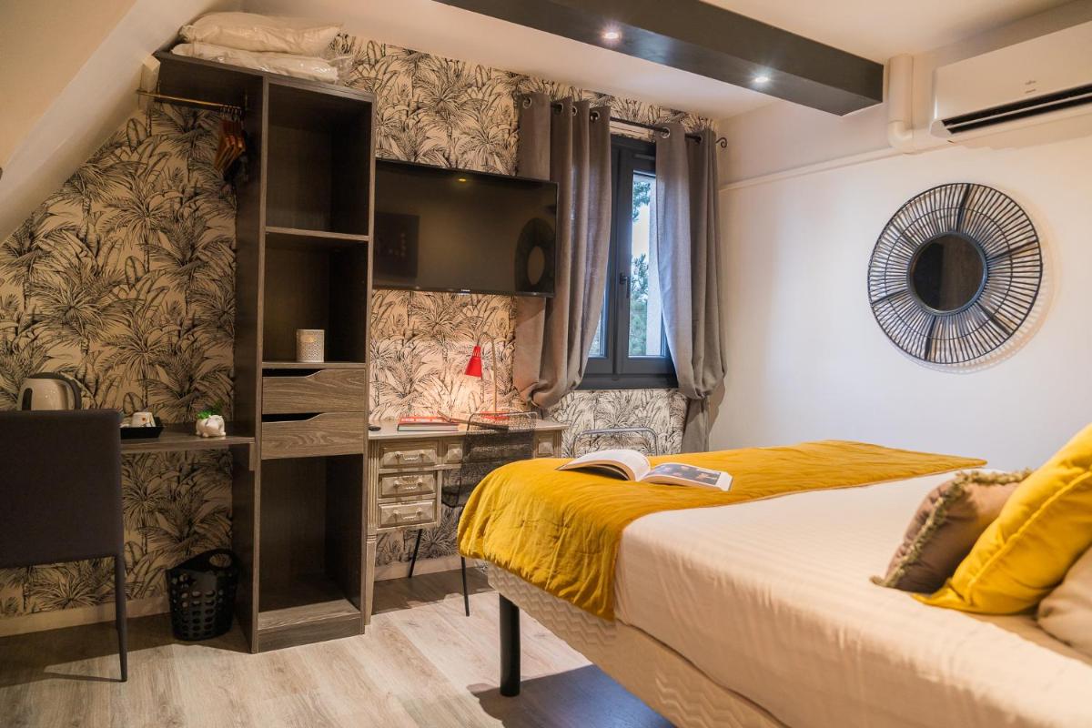 Un ou plusieurs lits dans un hébergement de l'établissement Les Terrasses de Saumur - Hôtel & Appartements - Restaurant & Spa (Logis)