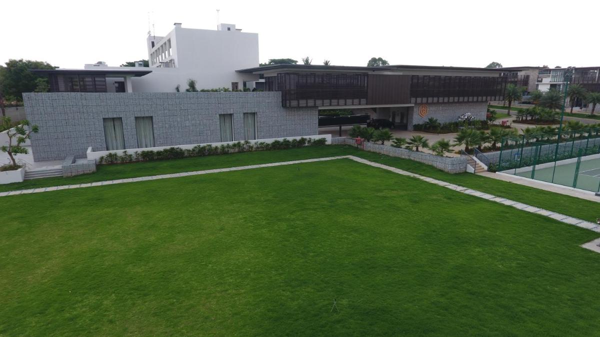 a large lawn in front of a building at BLVD Club - Near BENGALURU AIRPORT in Bengaluru
