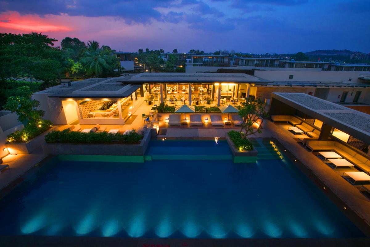 an aerial view of a building with a pool at night at BLVD Club - Near BENGALURU AIRPORT in Bengaluru an aerial view of a building with a pool at night at BLVD Club - Near BENGALURU AIRPORT in Bengaluru