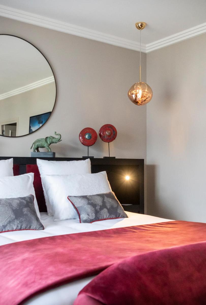 Un ou plusieurs lits dans un hébergement de l'établissement Hôtel L'Incomparable Aix-Les-Bains