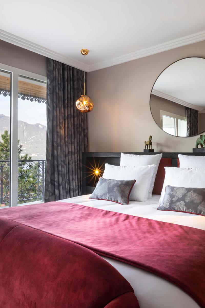 Un ou plusieurs lits dans un hébergement de l'établissement Hôtel L'Incomparable Aix-Les-Bains