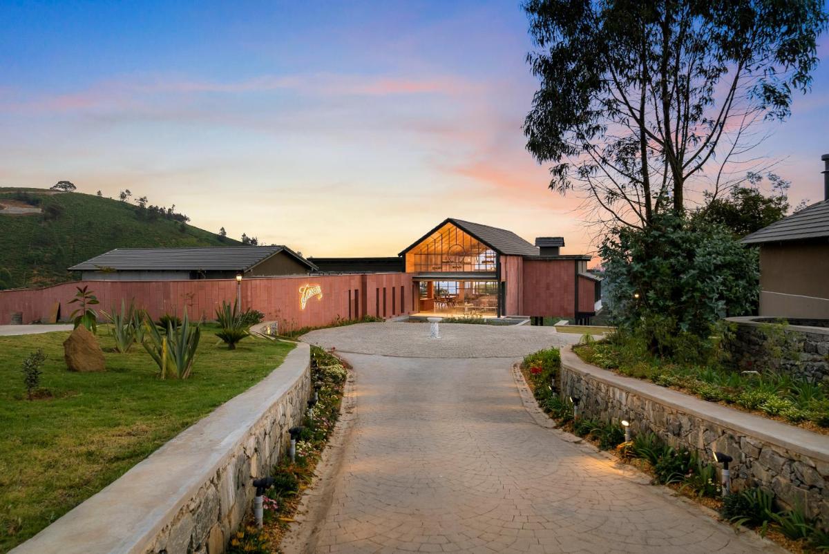 a house on a hill with a driveway at WelcomHeritage Ayatana Ooty in Ooty
